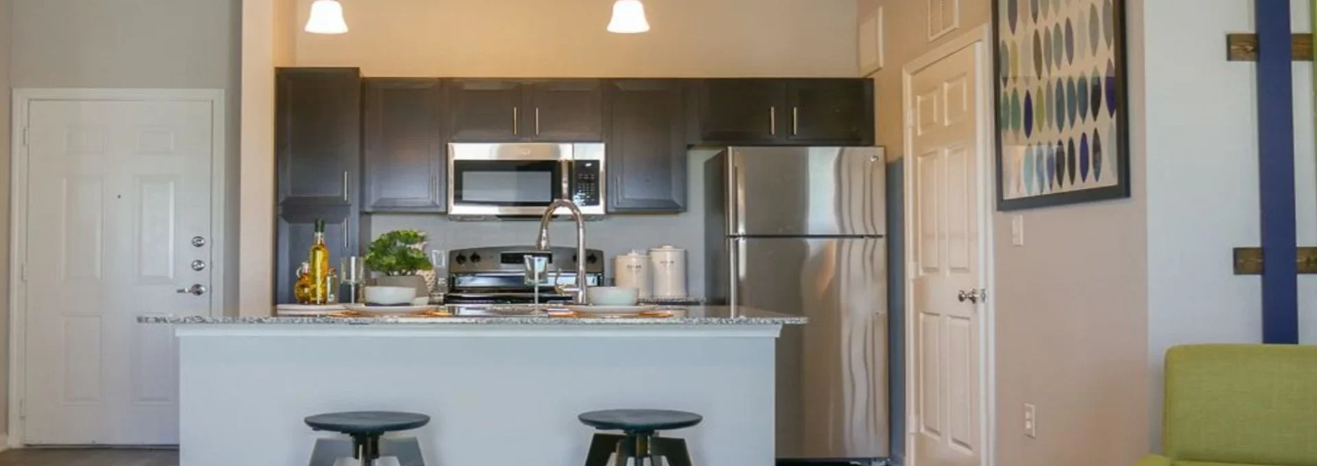 a kitchen with a large island and bar stools at The Biltmore at  Park