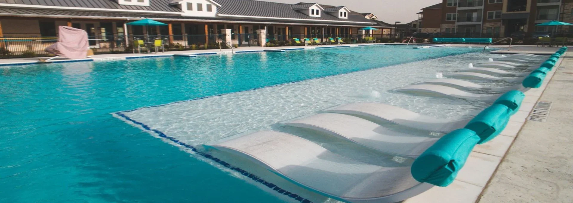 a large pool with lounge chairs and umbrellas at The Biltmore at  Park