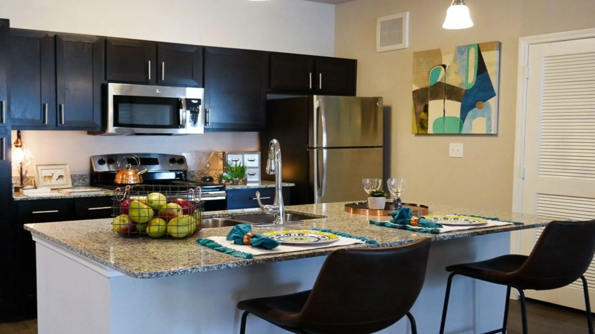 kitchen with granite counter tops and stainless steel appliances at The Biltmore at  Park